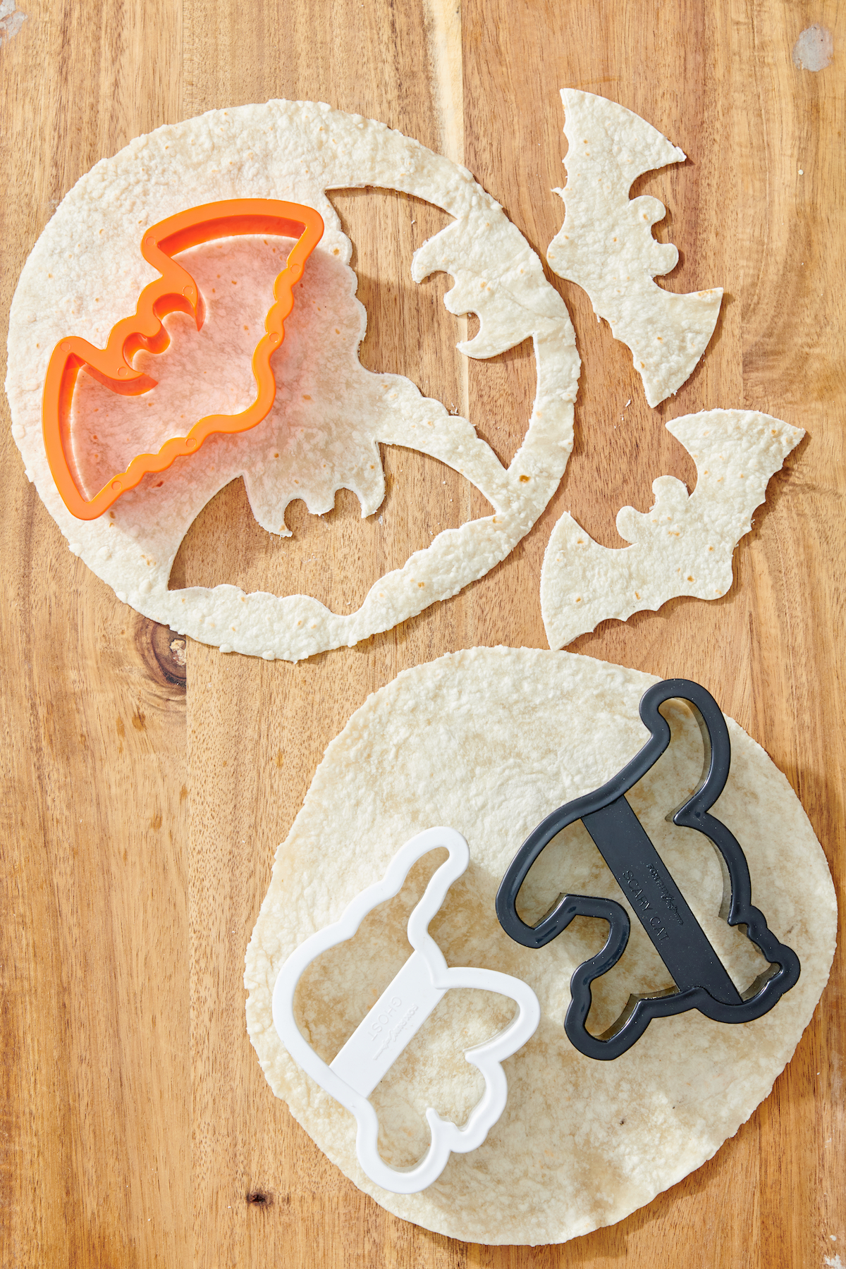 Bat cookie cutter cutting out bat shapes from tortilla.