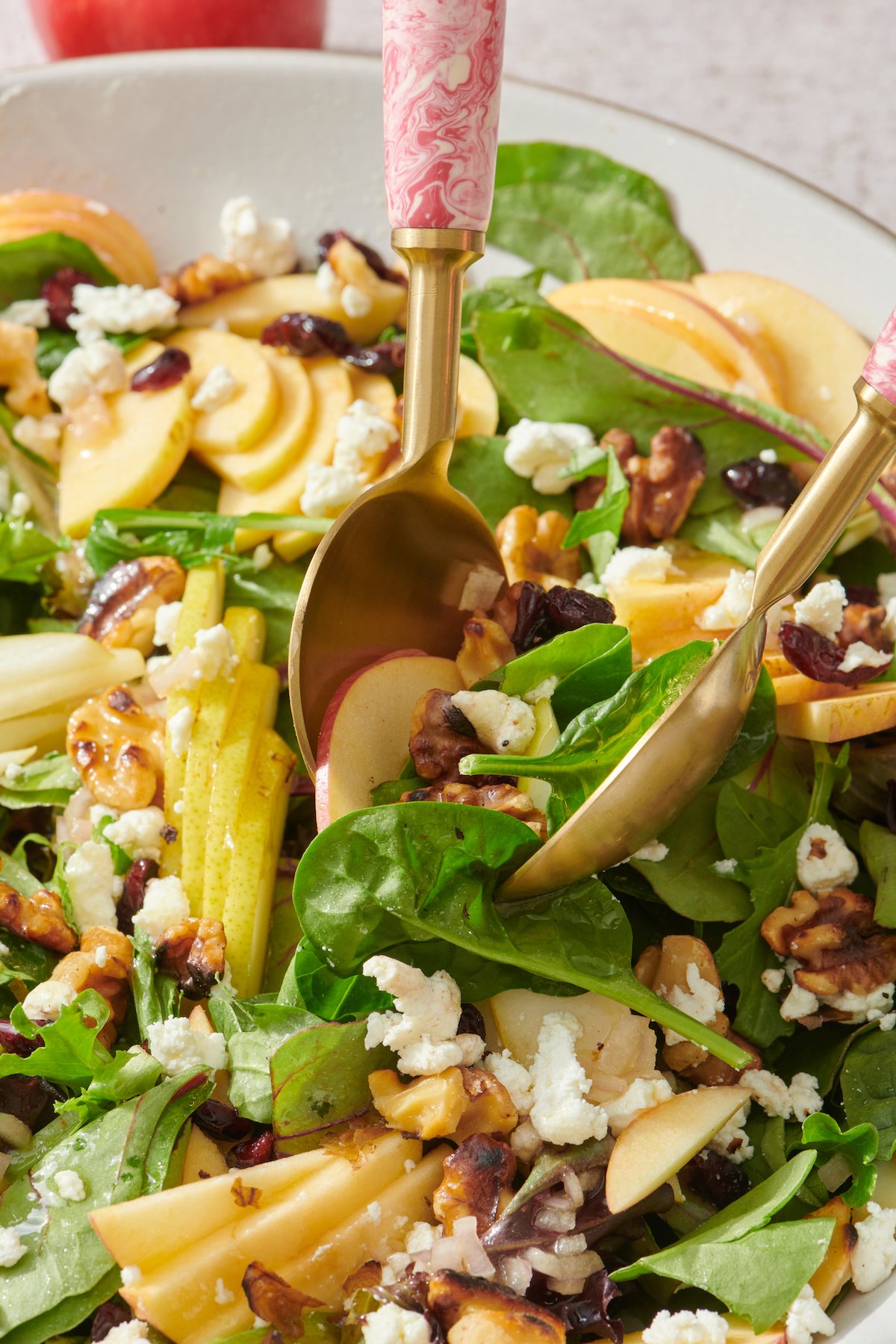 Serving Fall Salad with Apples, Pears and Goat Cheese.