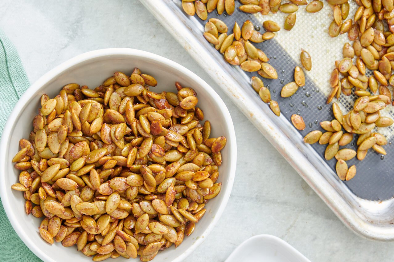 Overhead view of Maple Roast Pumpkin Seeds in a bowl.