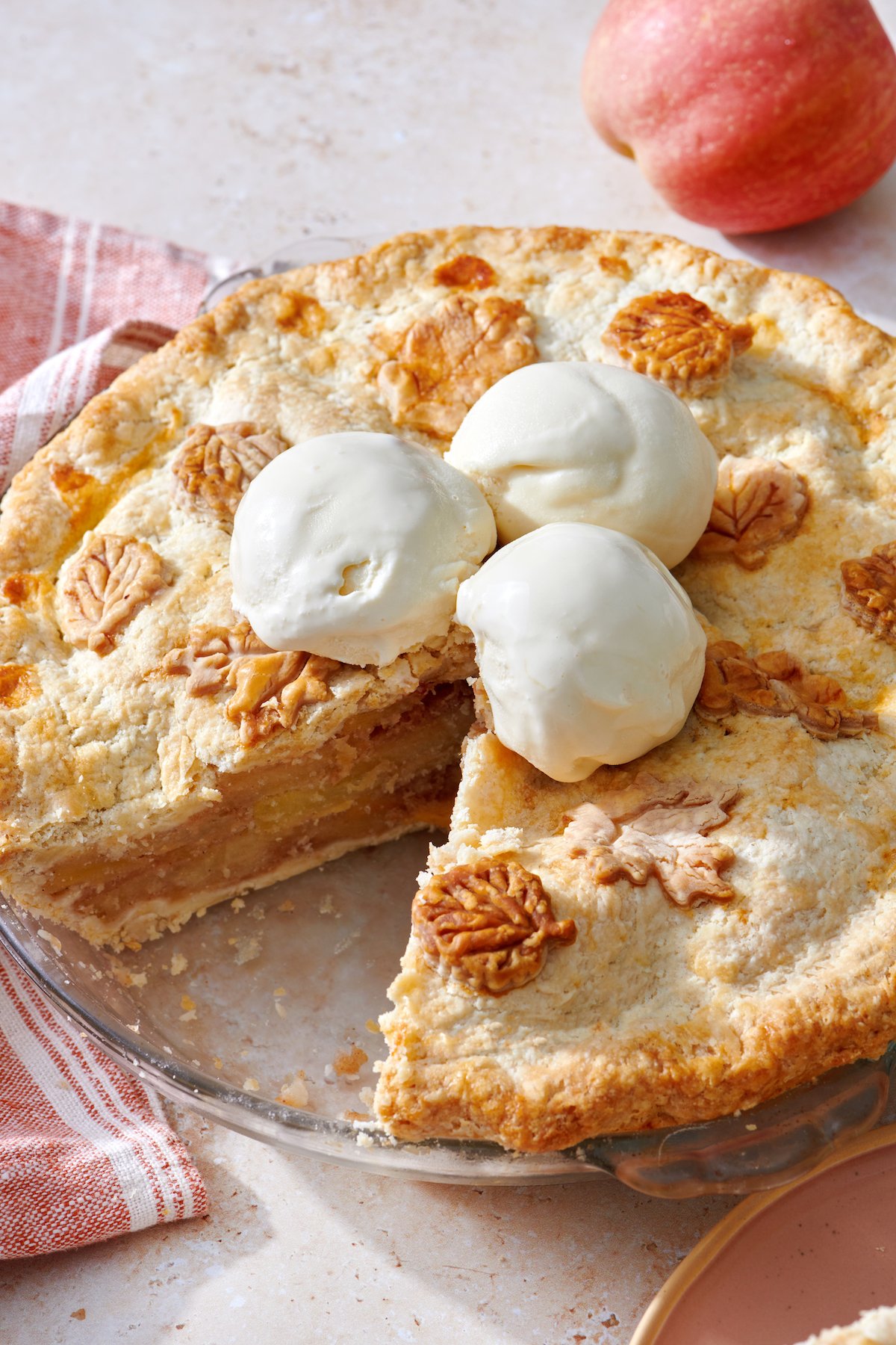 Apple Pie with slice removed, topped with ice cream.