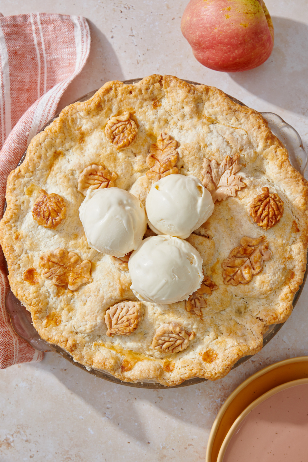 Apple pie topped with ice cream.