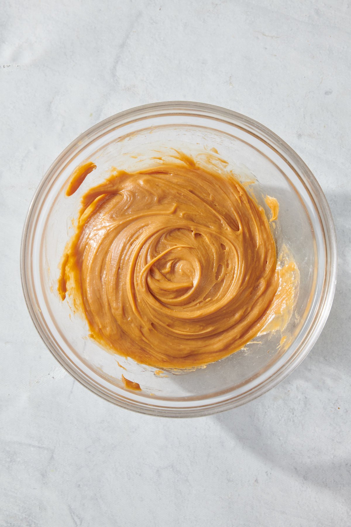 peanut butter and honey mixed in clear bowl