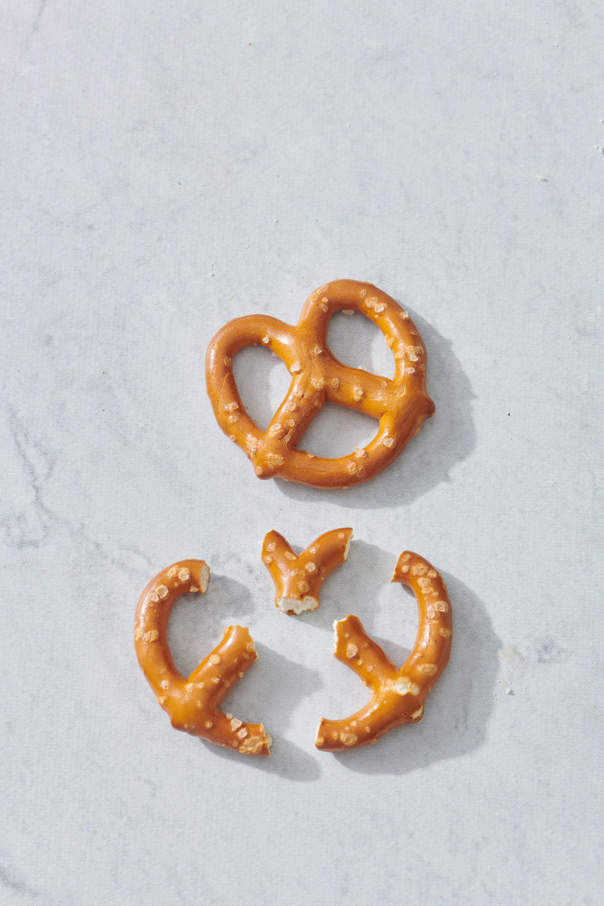 Whole pretzel with pretzel cut in half below.