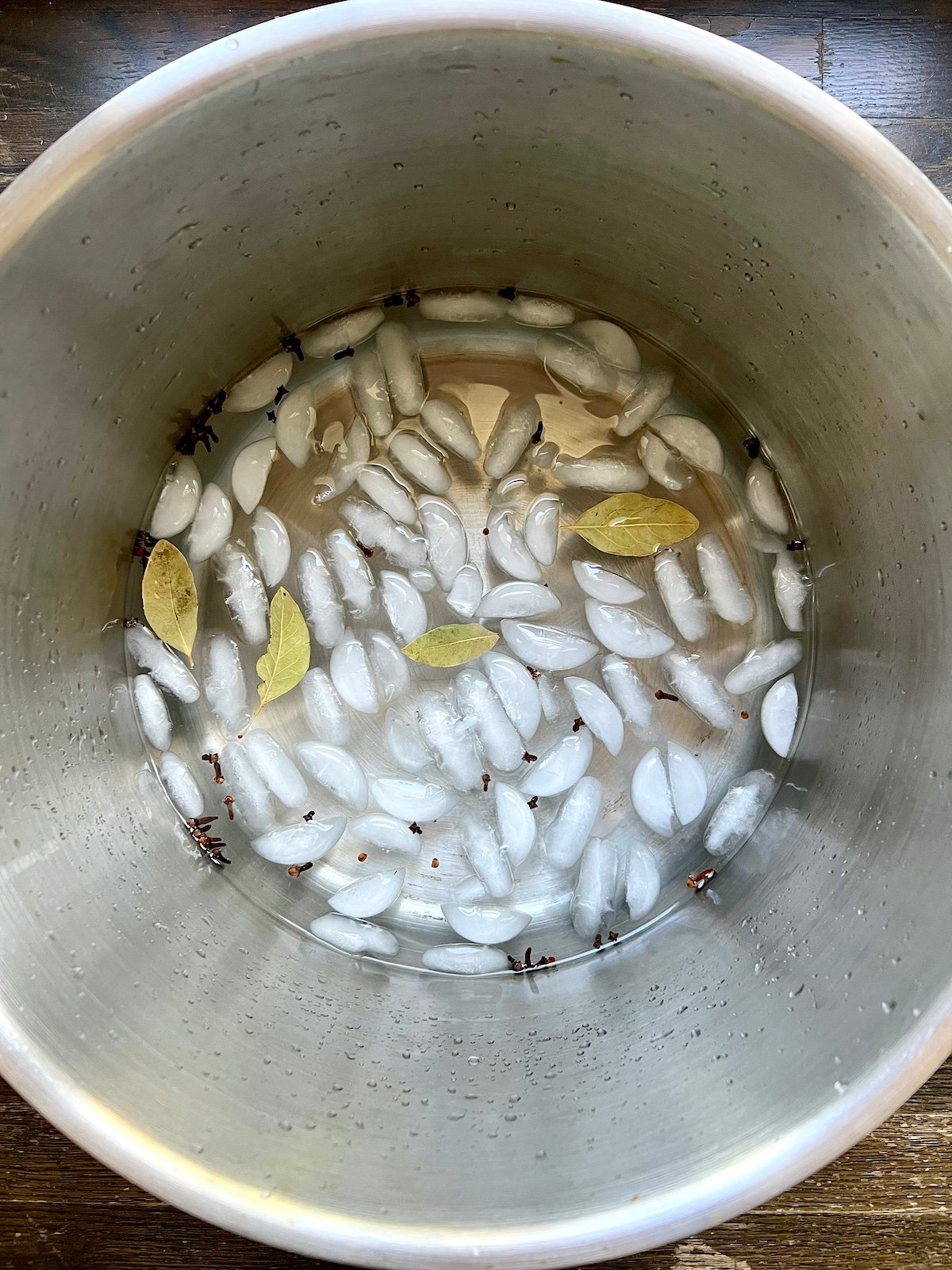 Bay leaves and ice cubes added to brine.