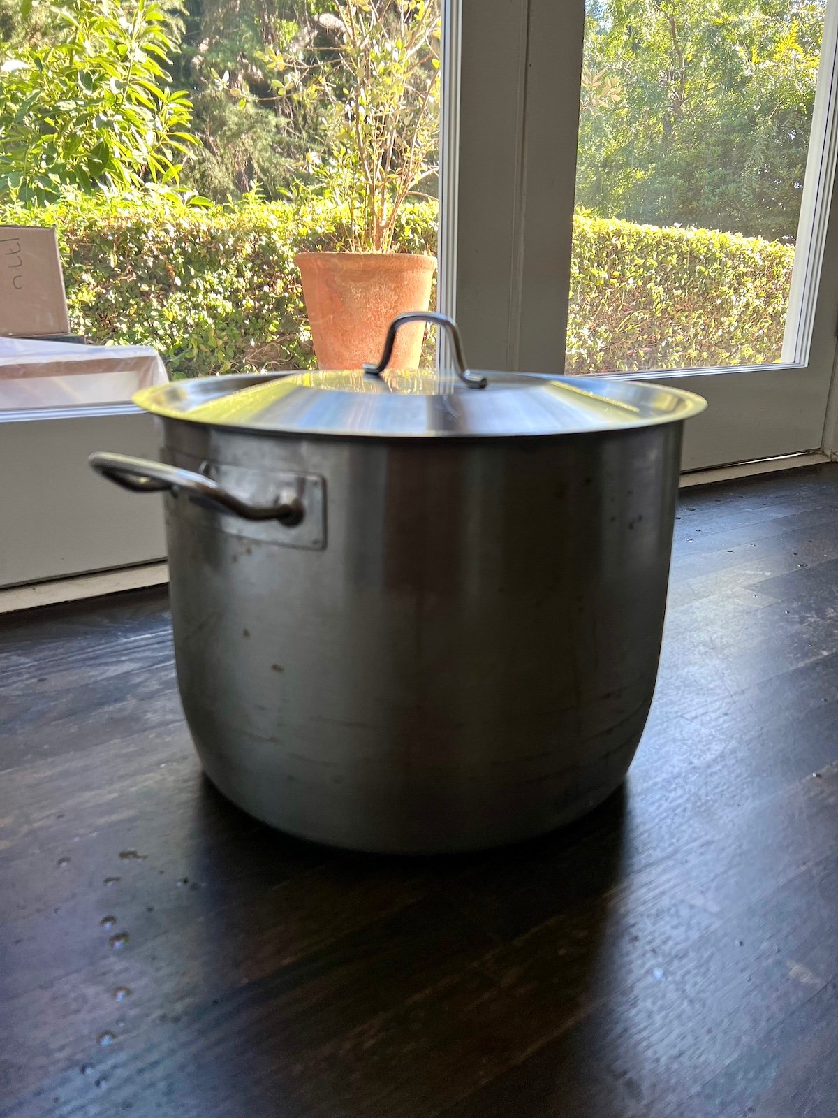 Covered stockpot with a brining turkey inside.