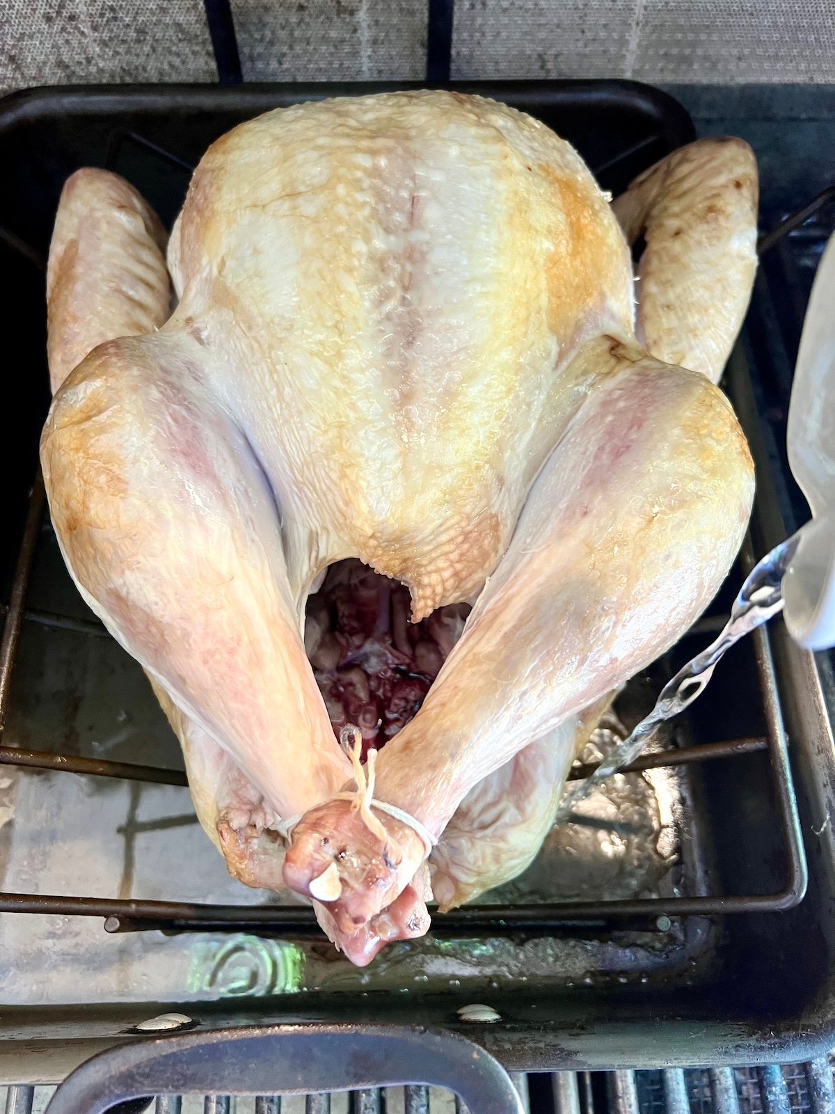 Pouring water in a roasting dish.