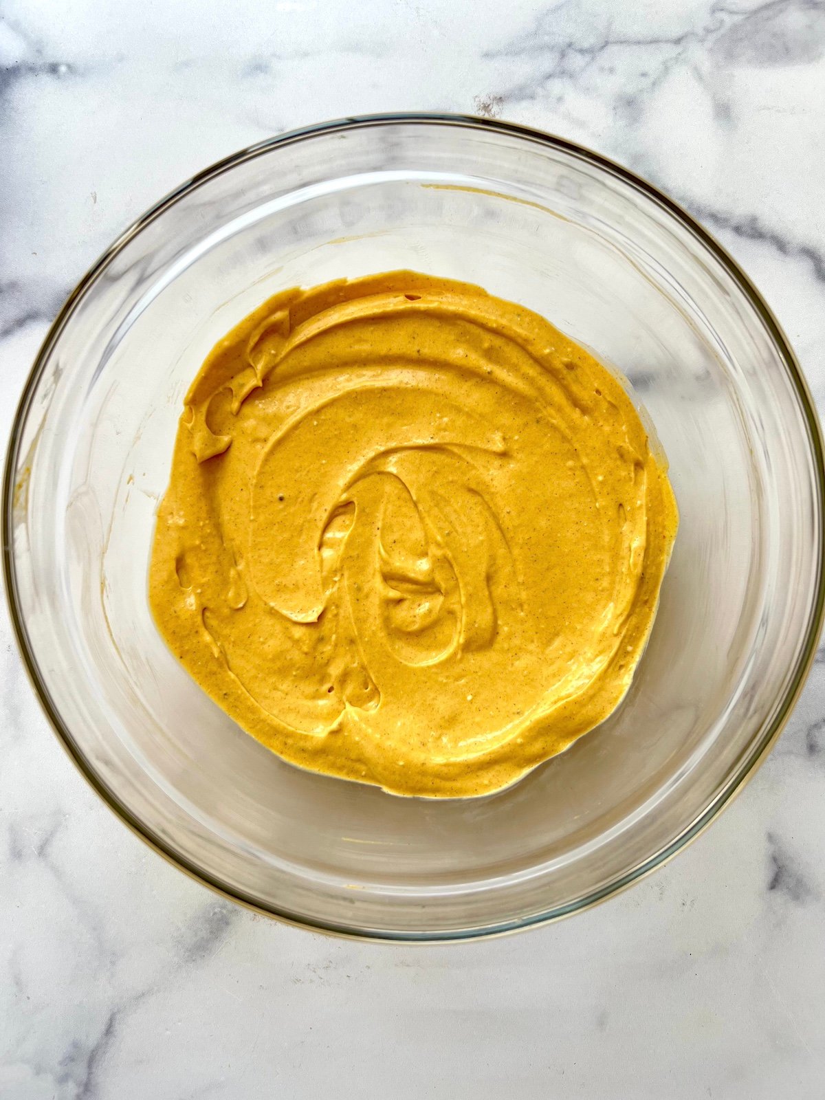 Pumpkin and cream cheese whipped in a bowl.