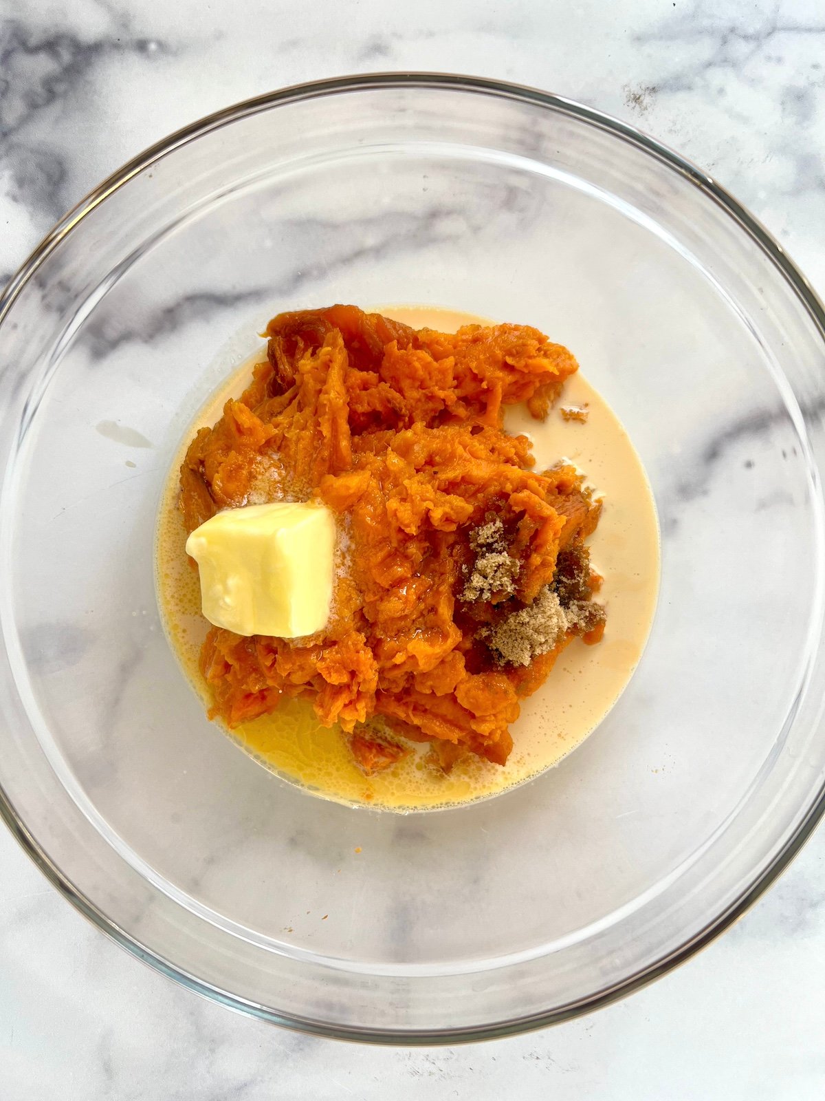 Sweet potato casserole ingredients in a bowl.