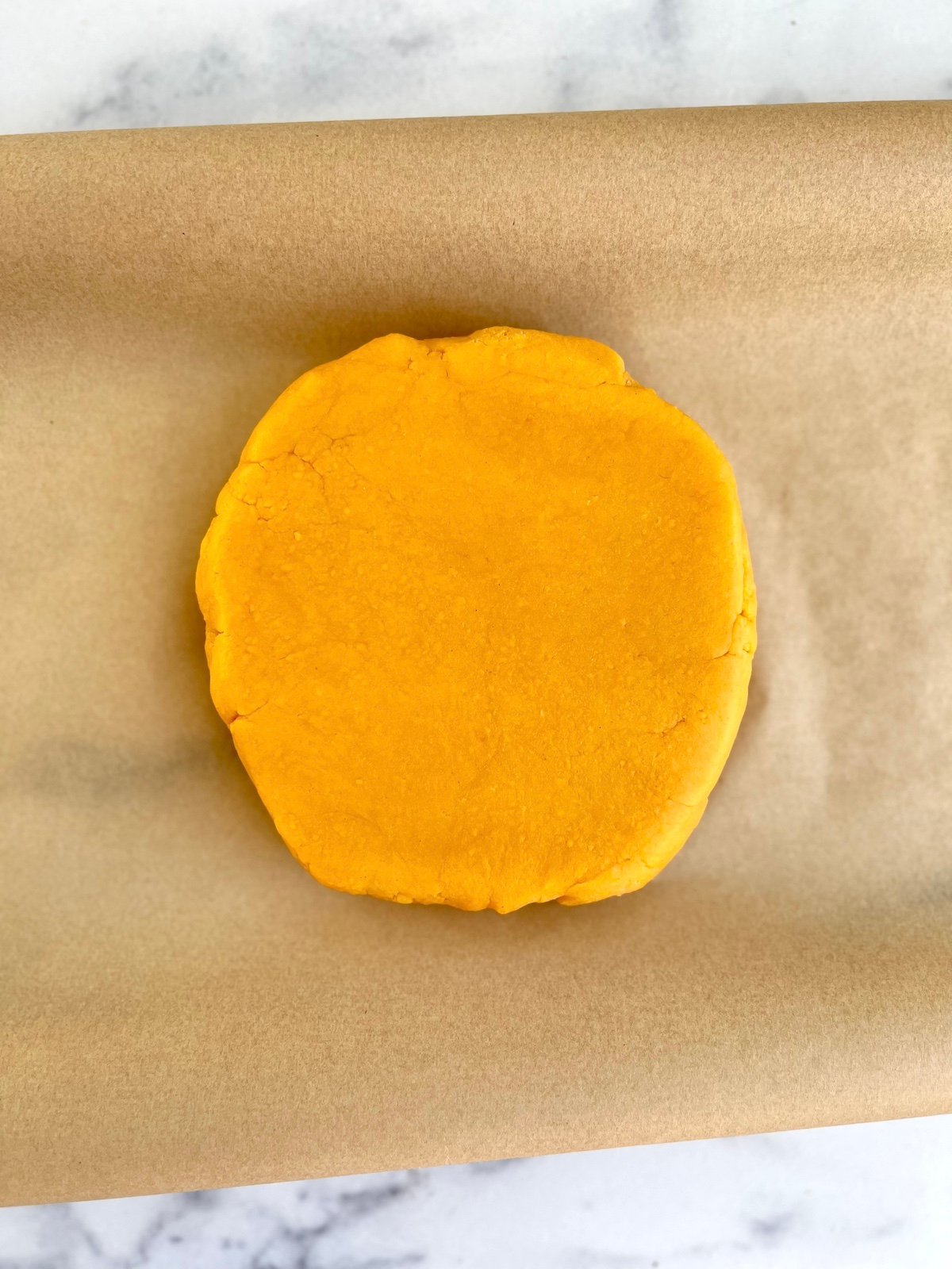 Cheese wafer dough on parchment paper.