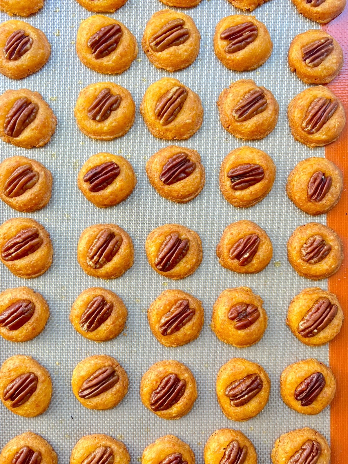 Cooked cheese wafers on a baking sheet.