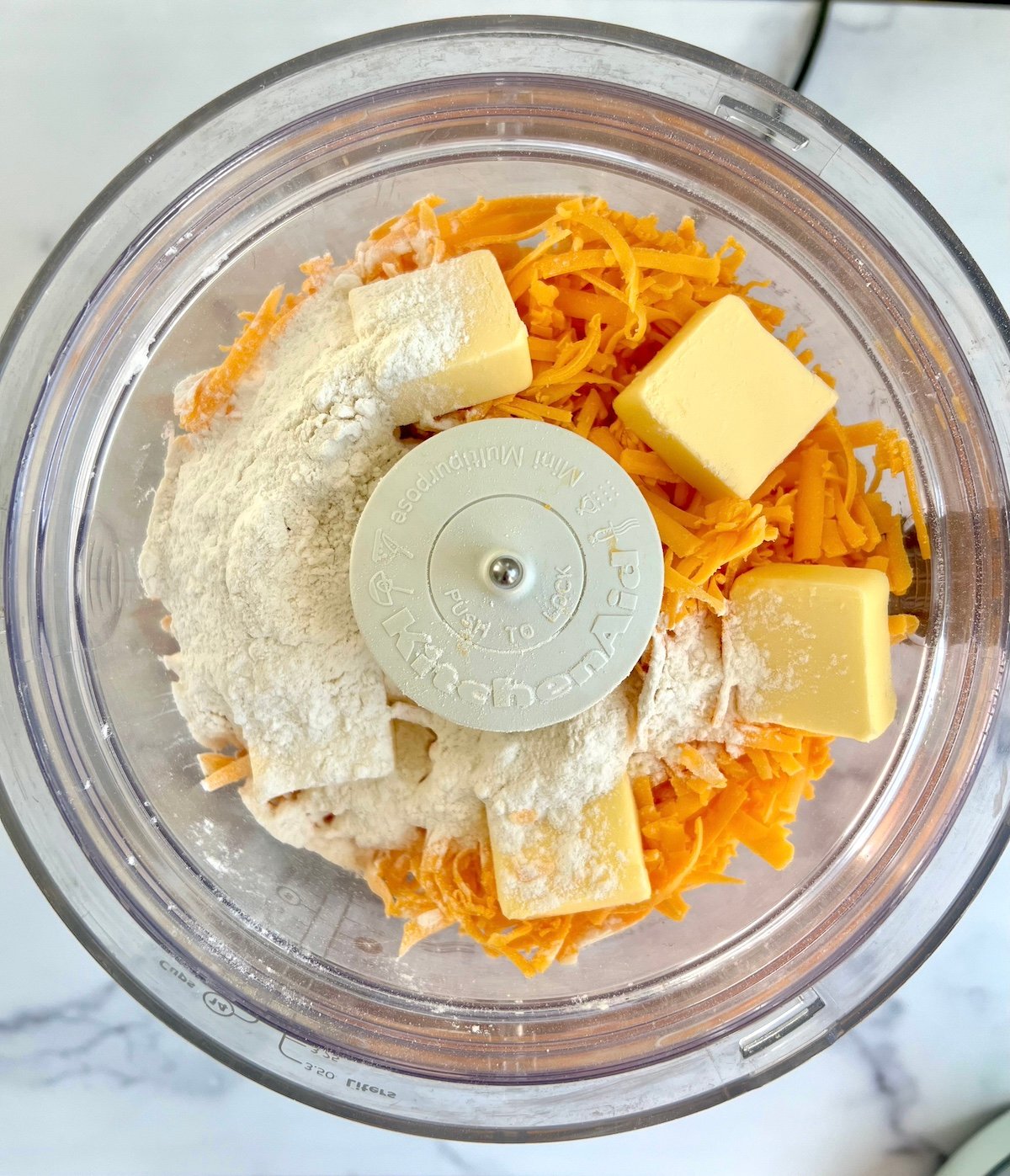 Ingredients for cheese wafers in a food processor.