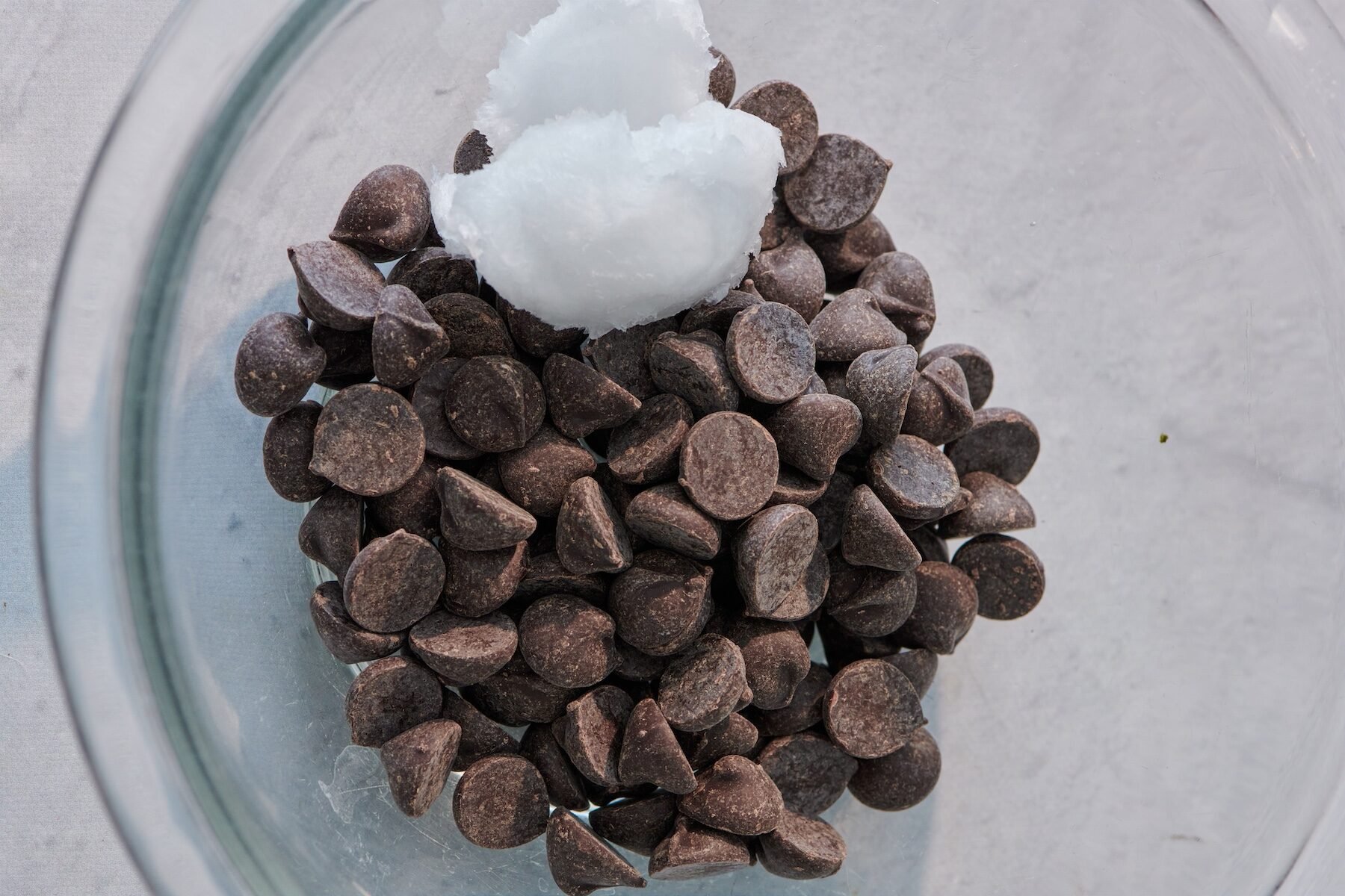 Chocolate chips and coconut oil in a bowl ready to be melted.