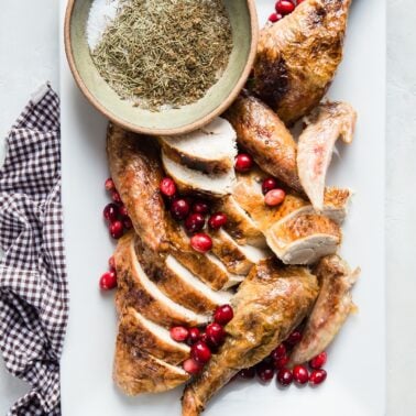 Carved herb brined turkey on serving platter.