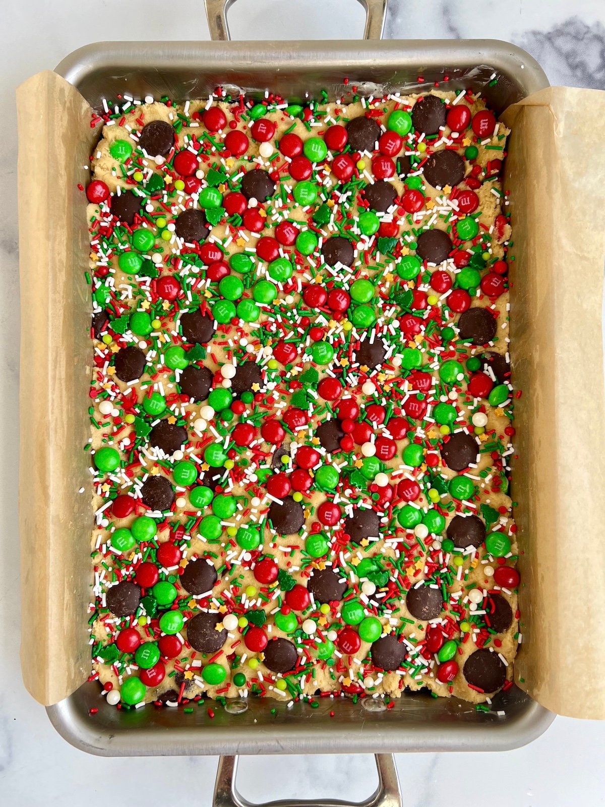 Cookie bar dough in a lined pan.