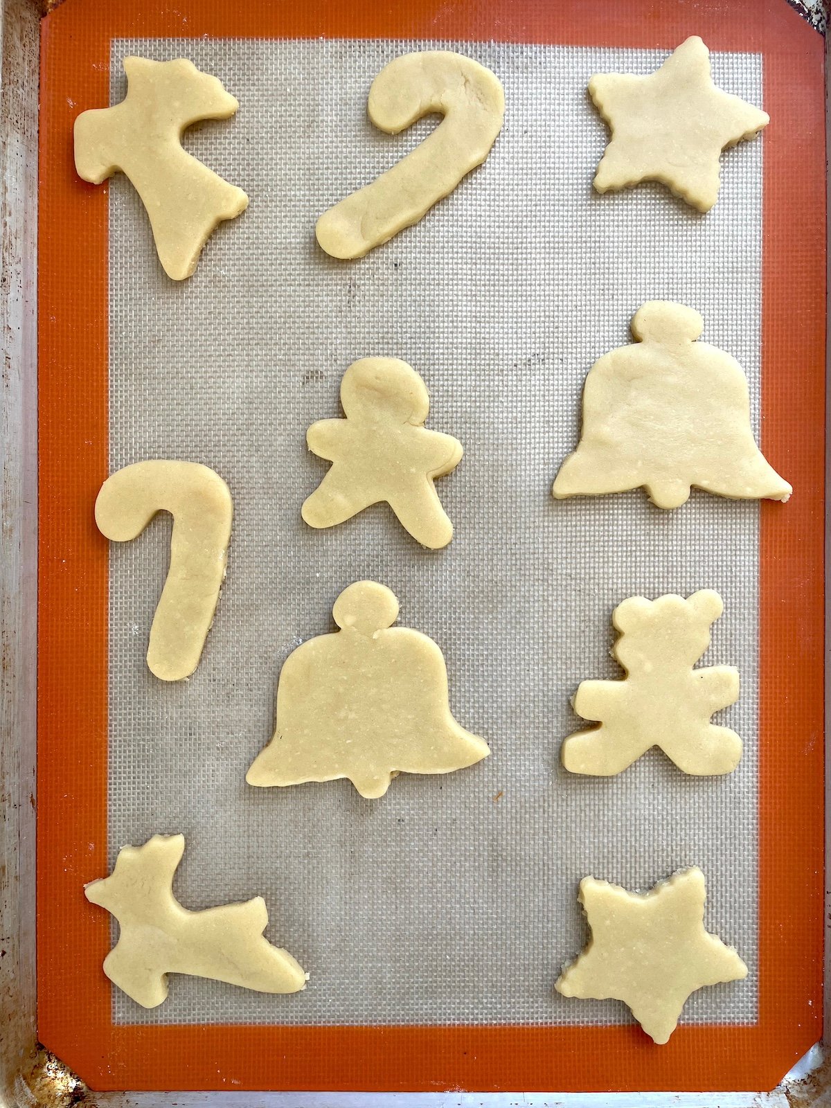 Unbaked sugar cookies on baking sheet.