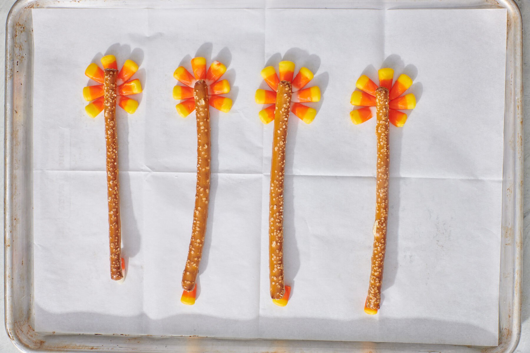 Pretzel rods on top of candy corns.