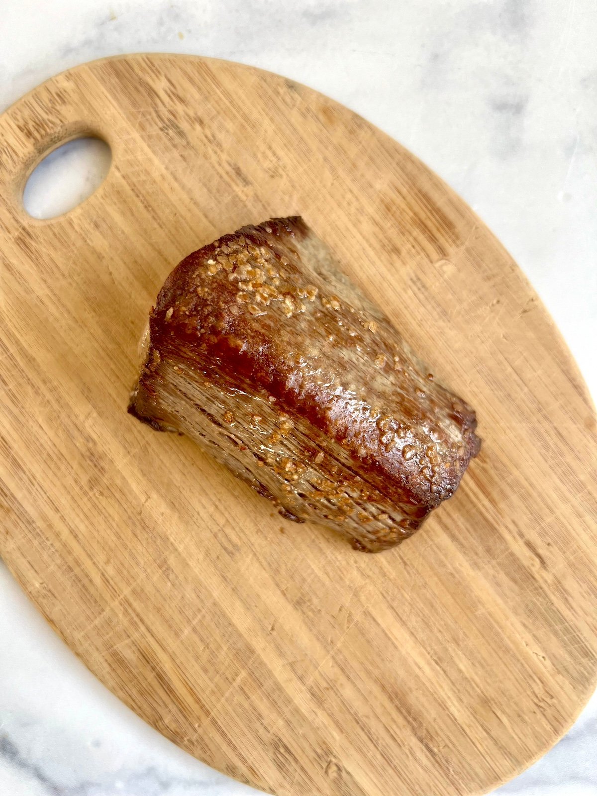 Beef Tenderloin resting on cutting board.