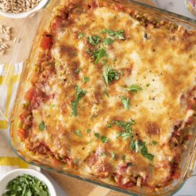 Baked farro with lentils, tomato and mozzarella in a baking dish.