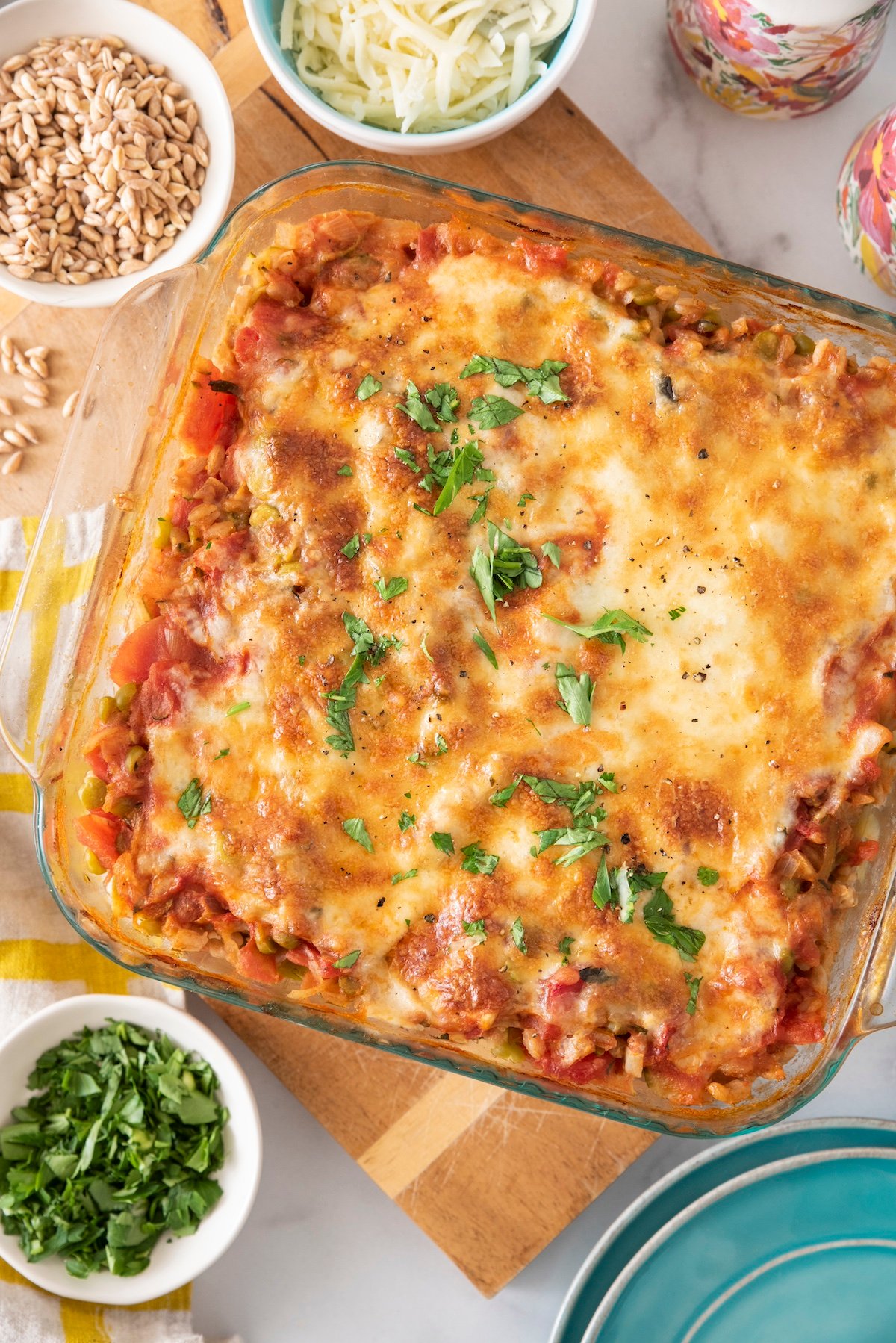 Baked farro with lentils, tomato and mozzarella in a baking dish.