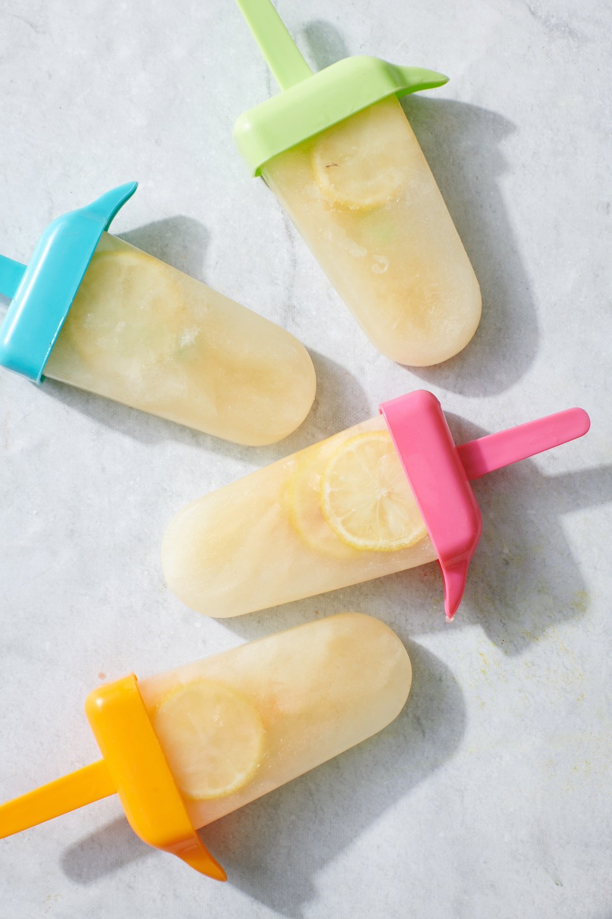 Wellness Electrolyte Popsicles on marble surface.