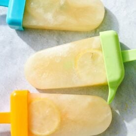 Three Wellness Electrolyte Popsicles on marble surface.