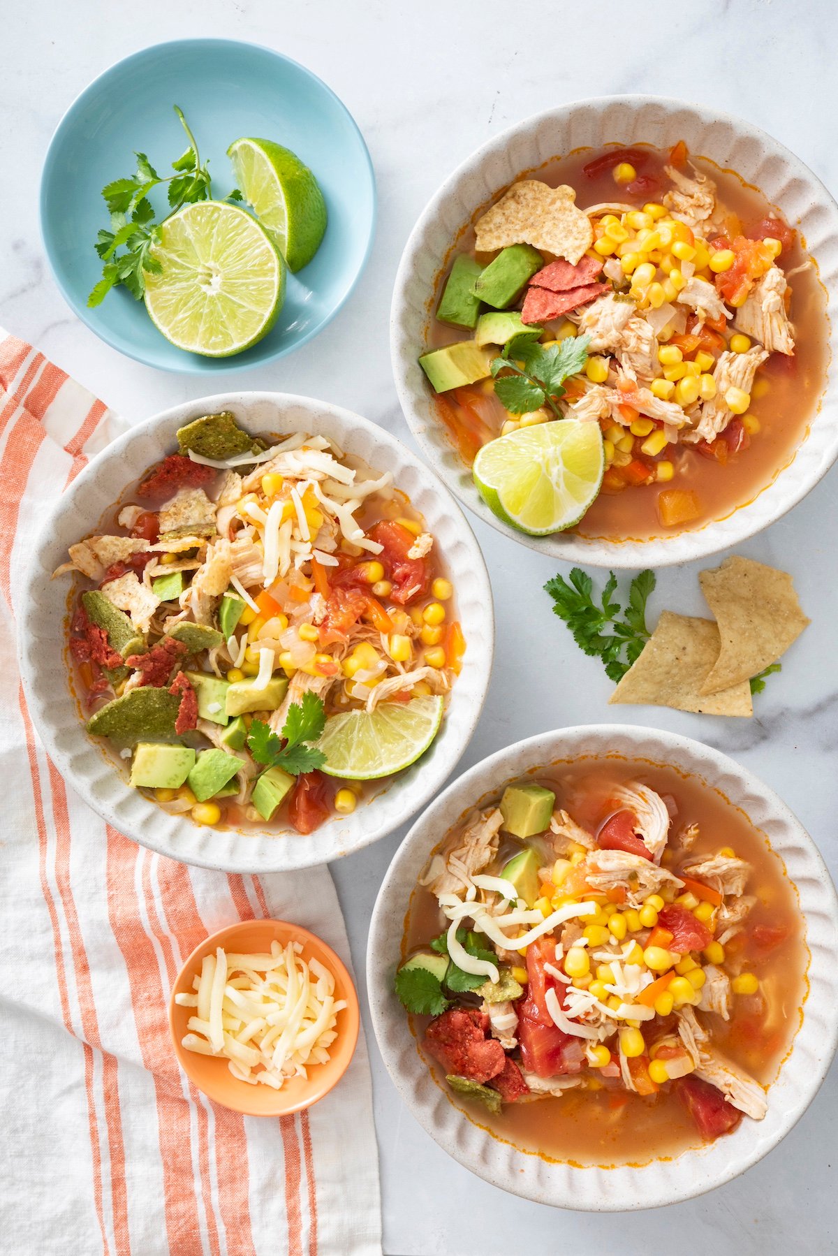 Three bowls of chicken tortilla soup.