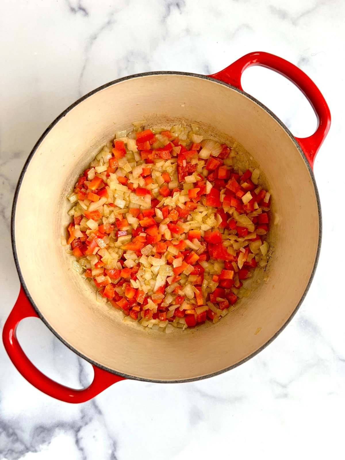 Sautéed vegetables in a pot for chicken tortilla soup.