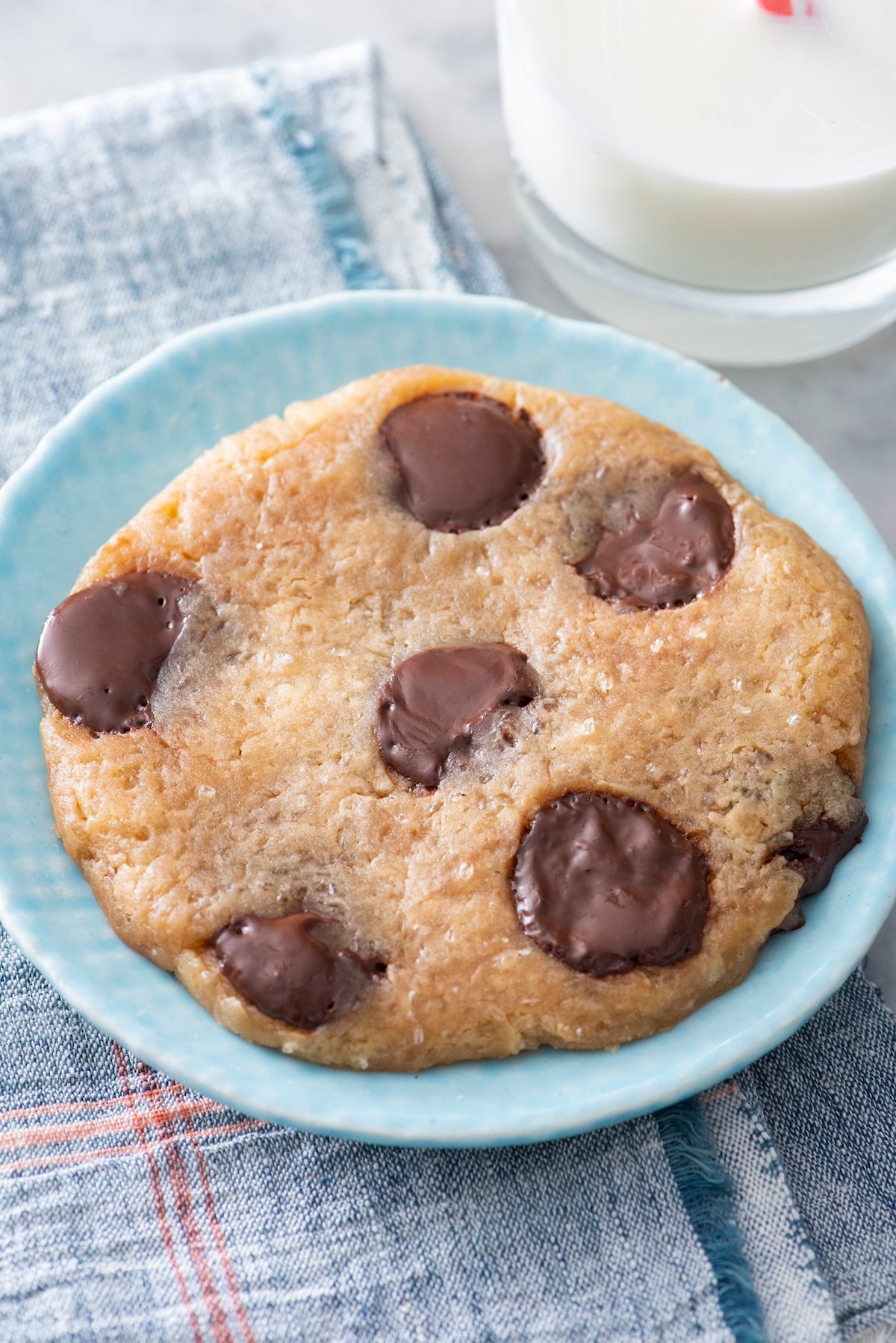 Microwave chocolate chip cookie on a plate.