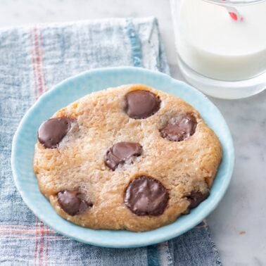 Microwave chocolate chip cookie on a plate.