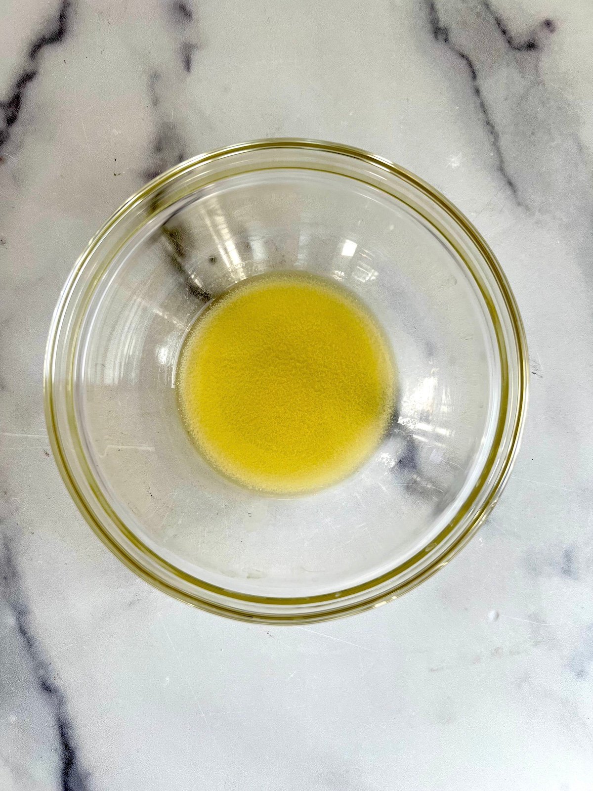 Melted butter in a glass bowl.