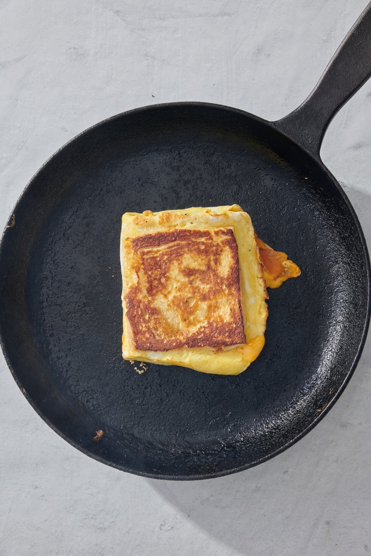 Breakfast sandwich in skillet.