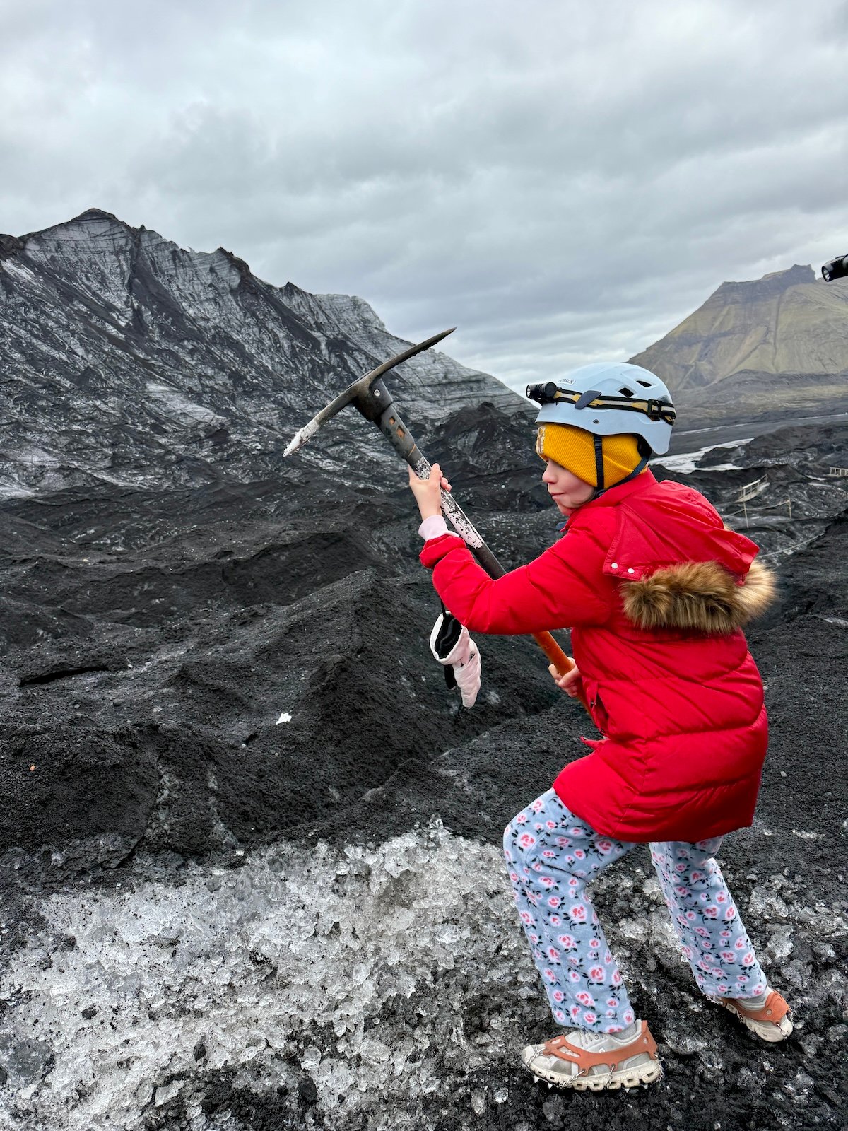 Girl with a pickax on a glacier in Iceland.