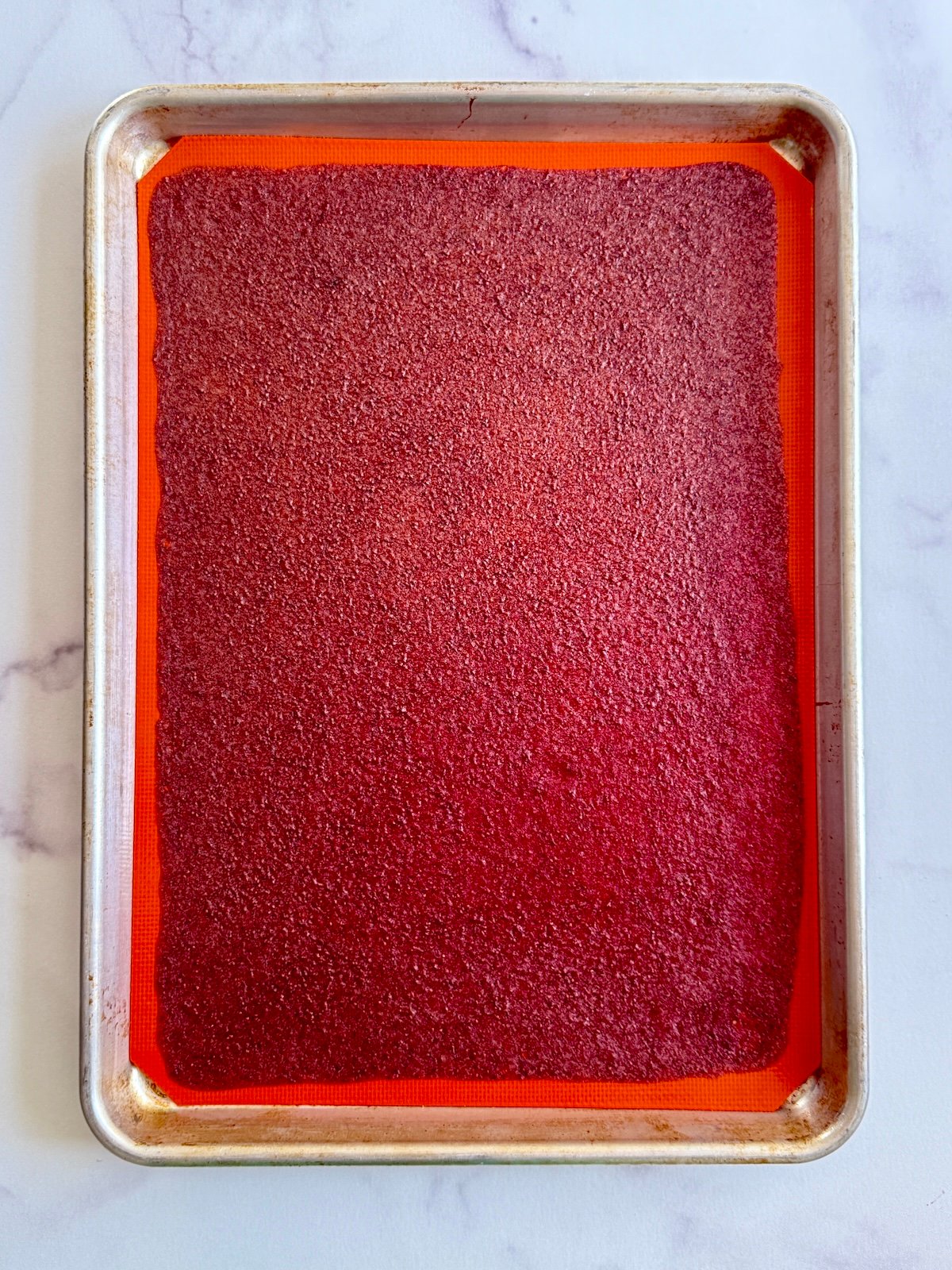 Fruit leather on baking sheet before cutting into strips.