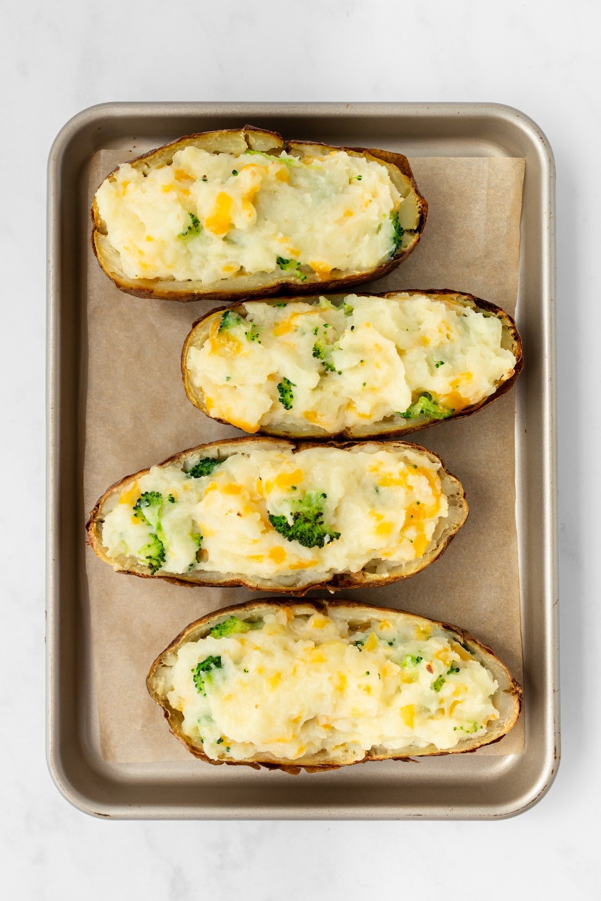 Twice baked potatoes on a baking sheet.
