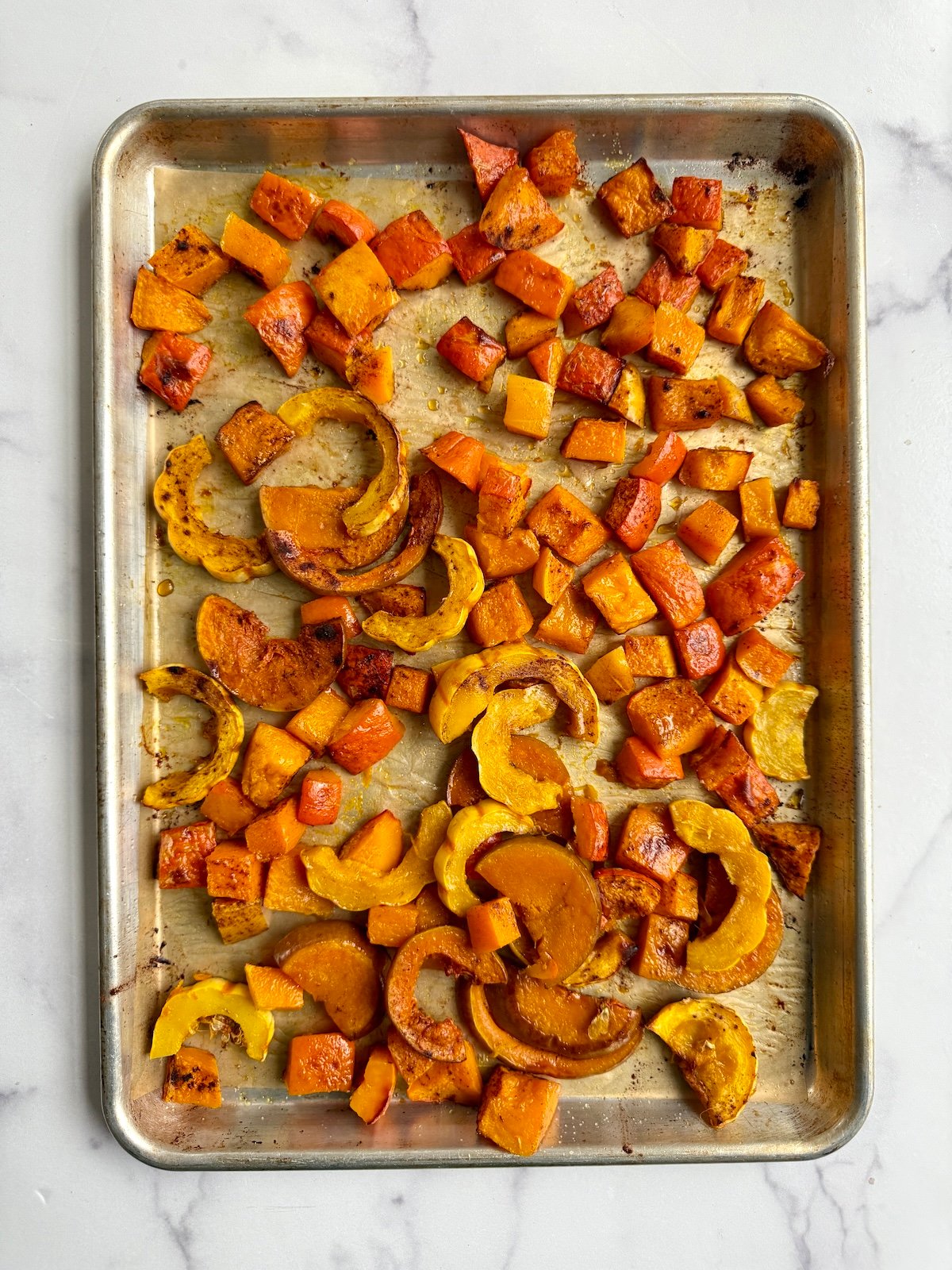 Cinnamon roast squash on a baking sheet.