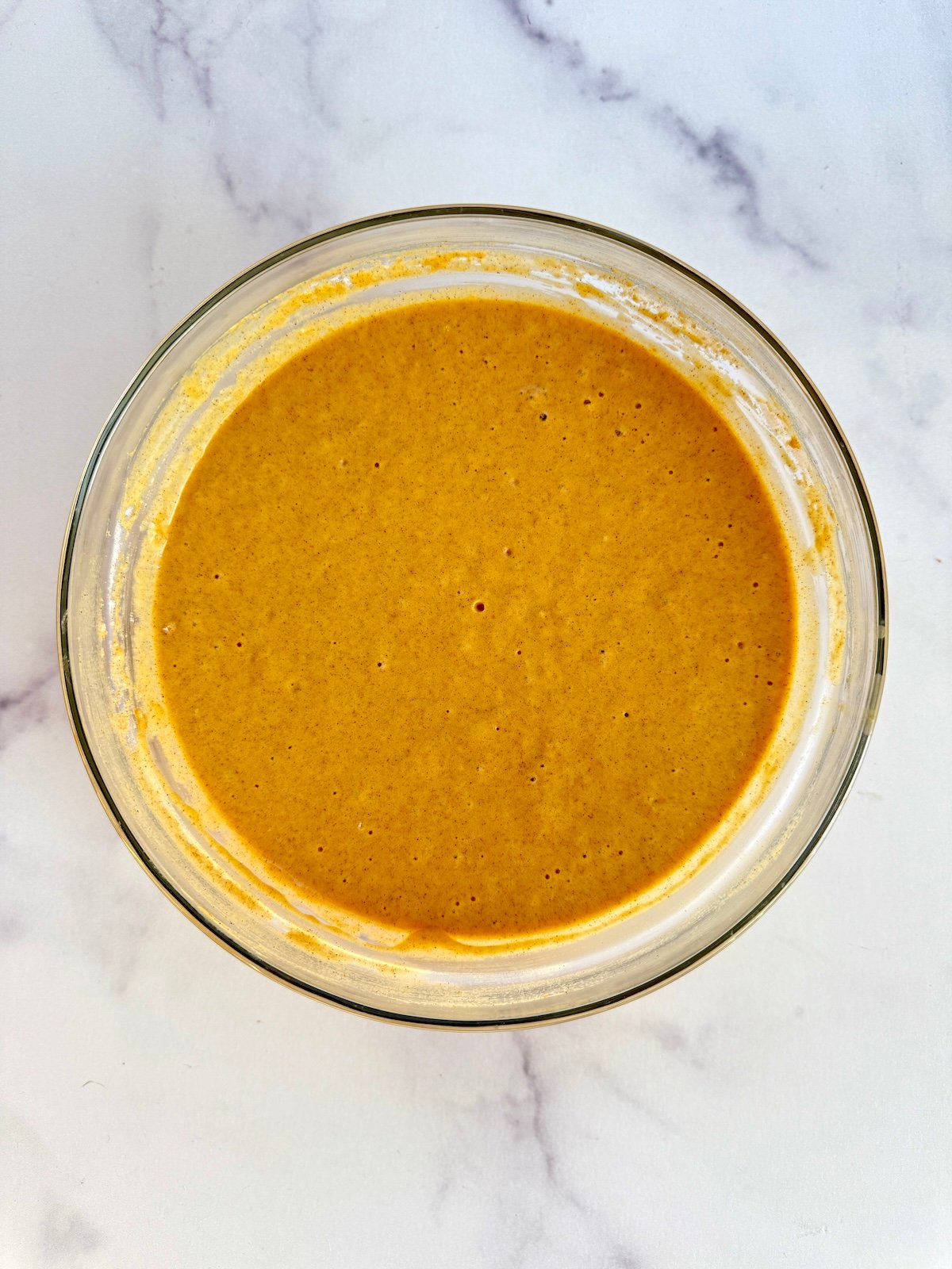 Pumpkin waffles batter in a bowl.