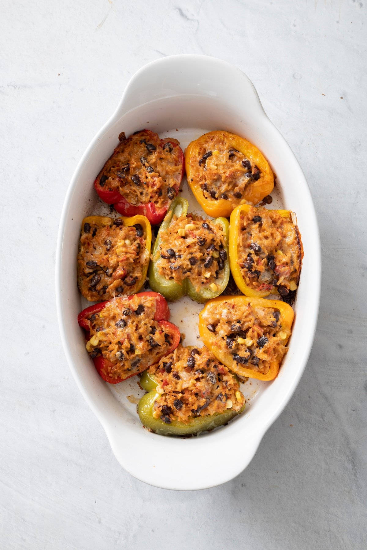 Baked stuffed peppers in a baking dish.