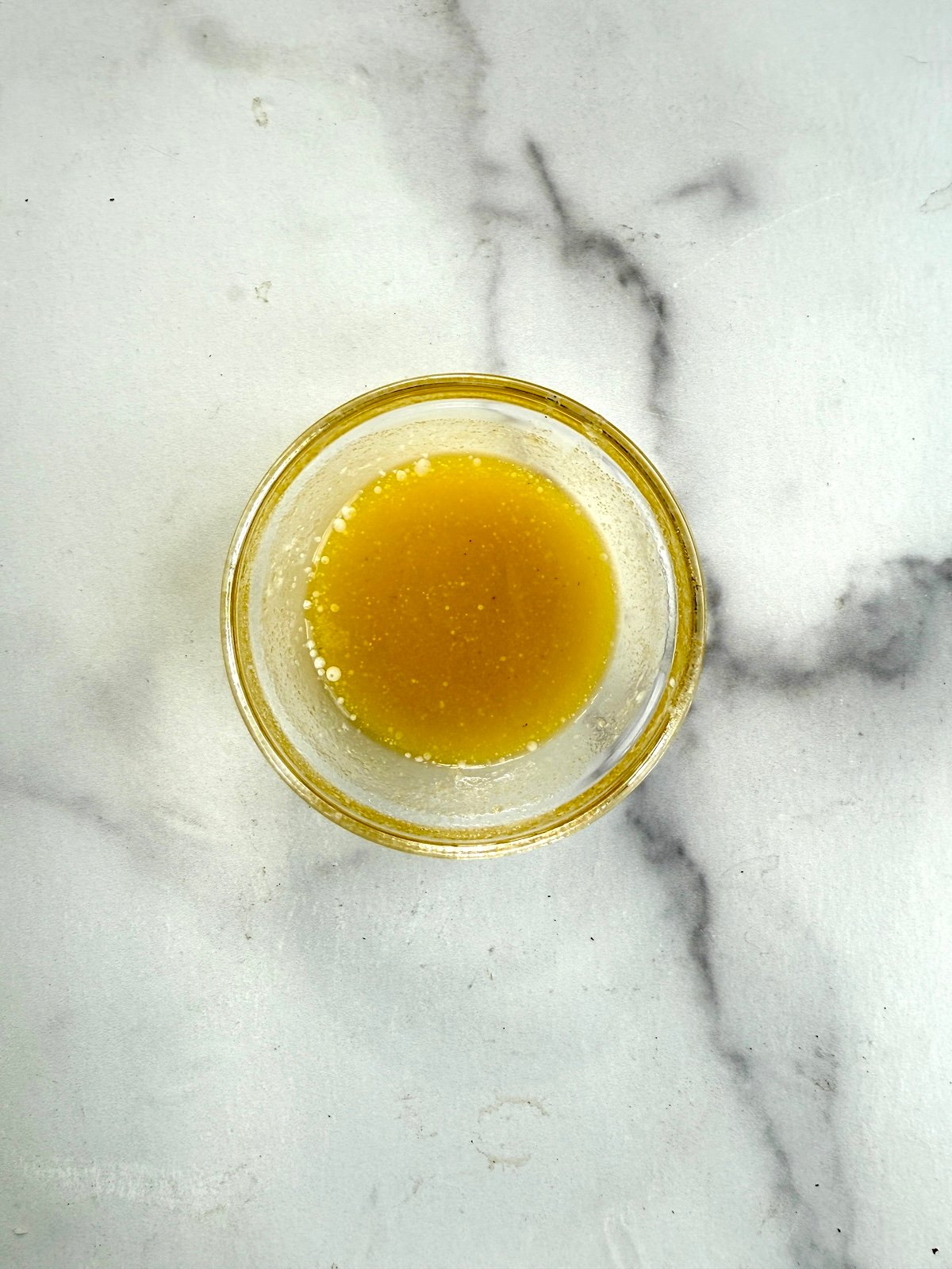 Melted butter and oil in a small bowl.