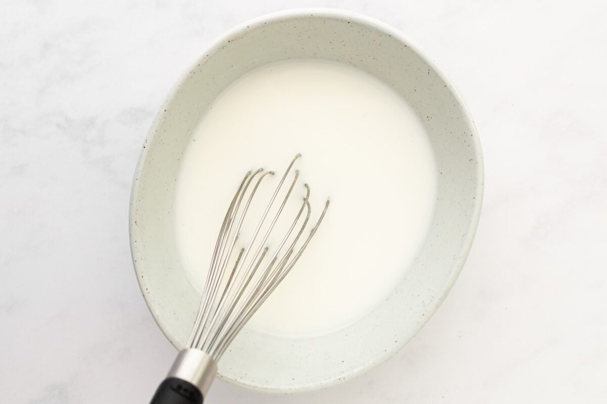 Buttermilk and salt whisked in a bowl.