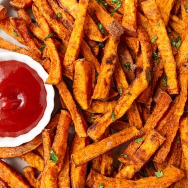 Sweet potato fries served with ketchup.