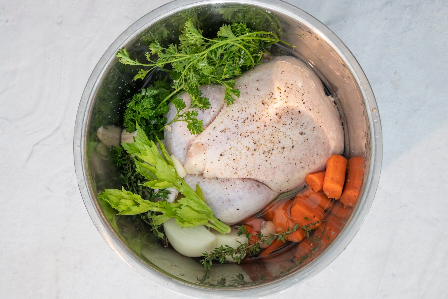 Ingredients for pressure cooker chicken soup in a pressure cooker.
