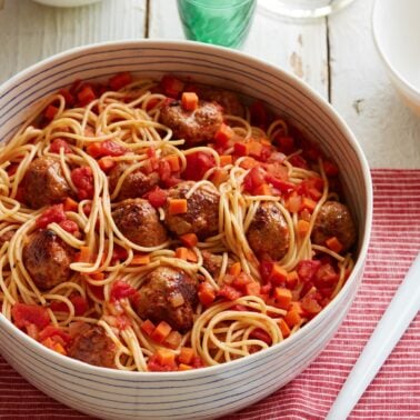 Spaghetti and turkey meatballs in a serving bowl.