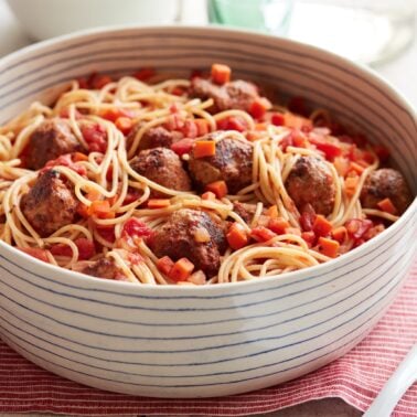 Spaghetti with turkey meatballs in a white bowl.