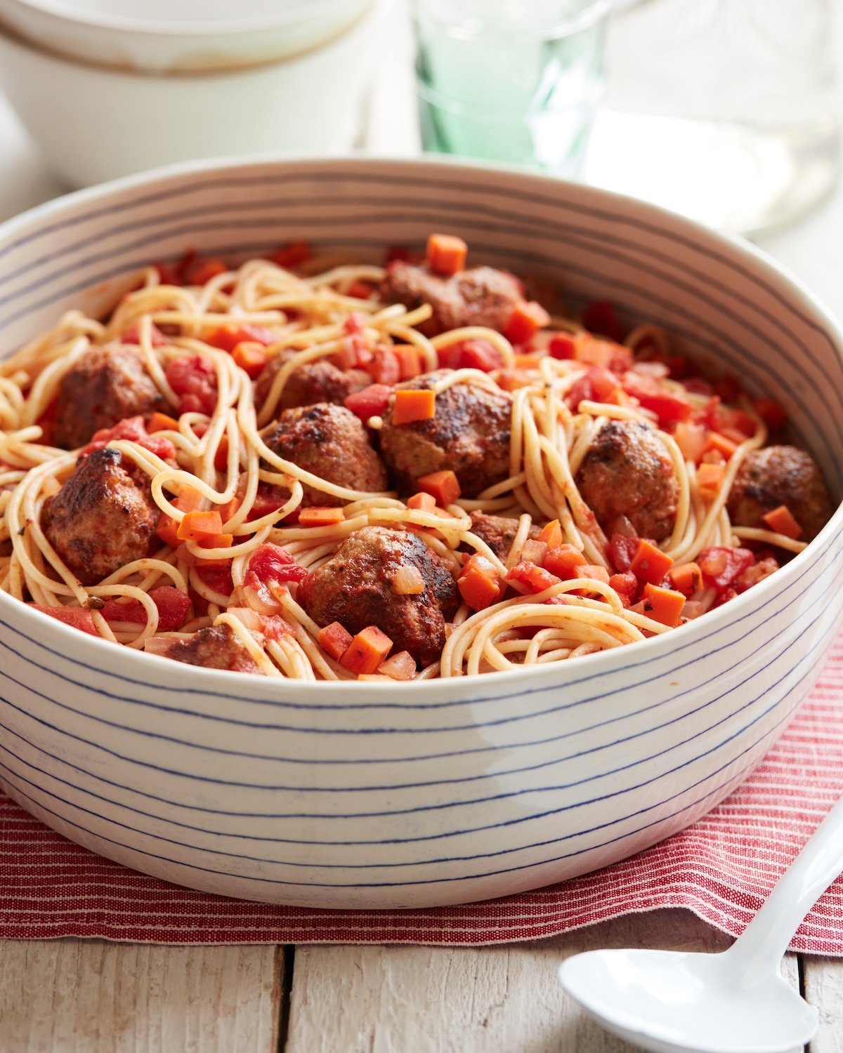 Spaghetti with turkey meatballs in a white bowl.