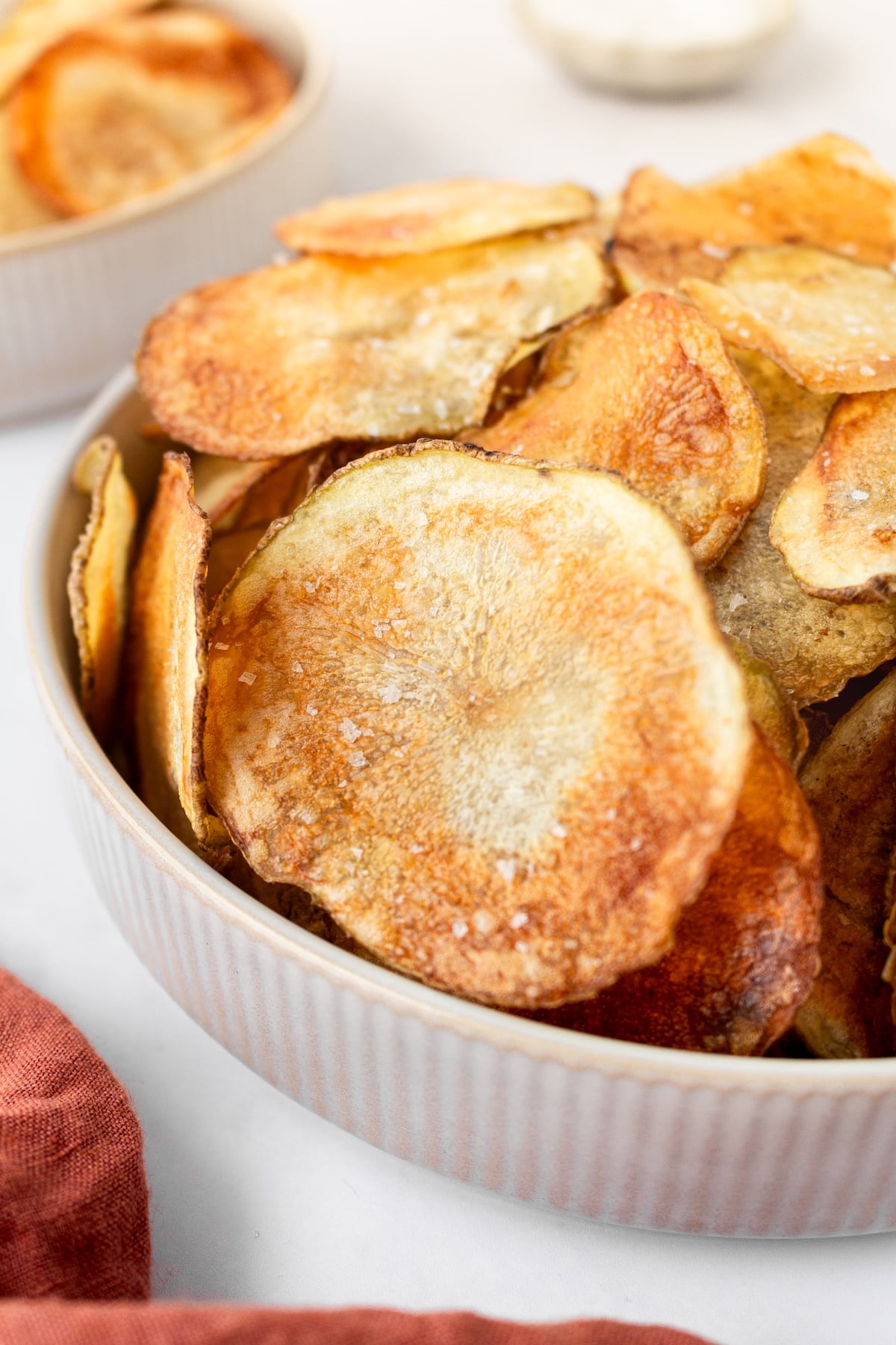 A bowl of homemade baked potato chips.