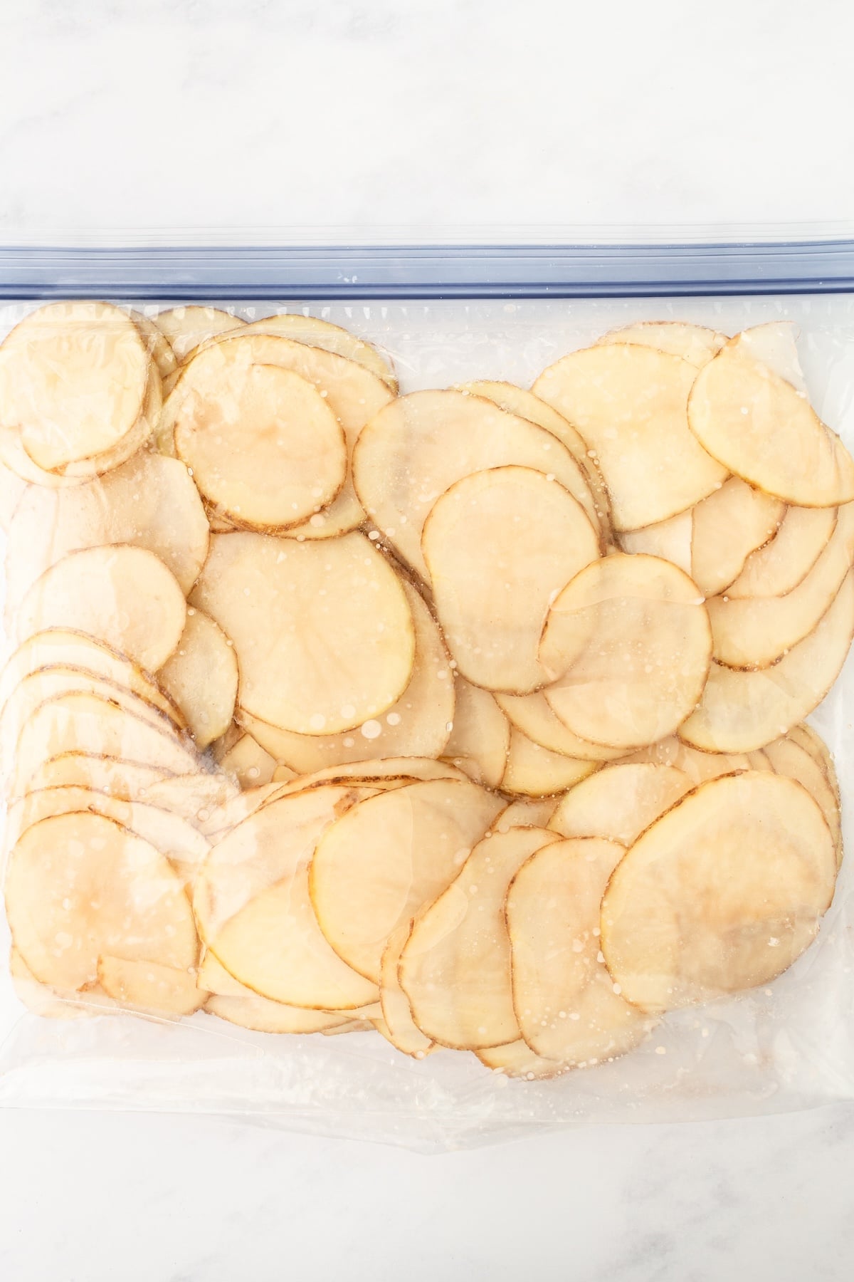 Resealable zipper bag with potatoes slices.