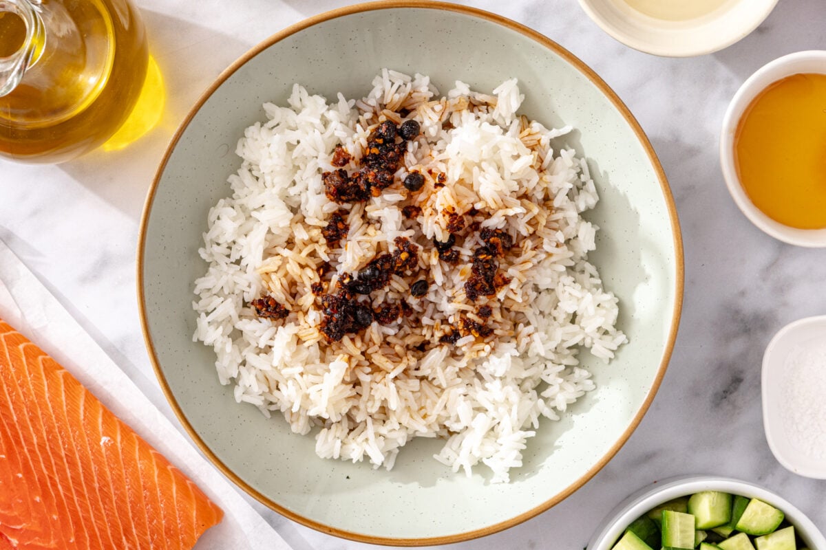 Cooked jasmine rice with chili crisp in a bowl ready to season for crispy rice salmon salad.