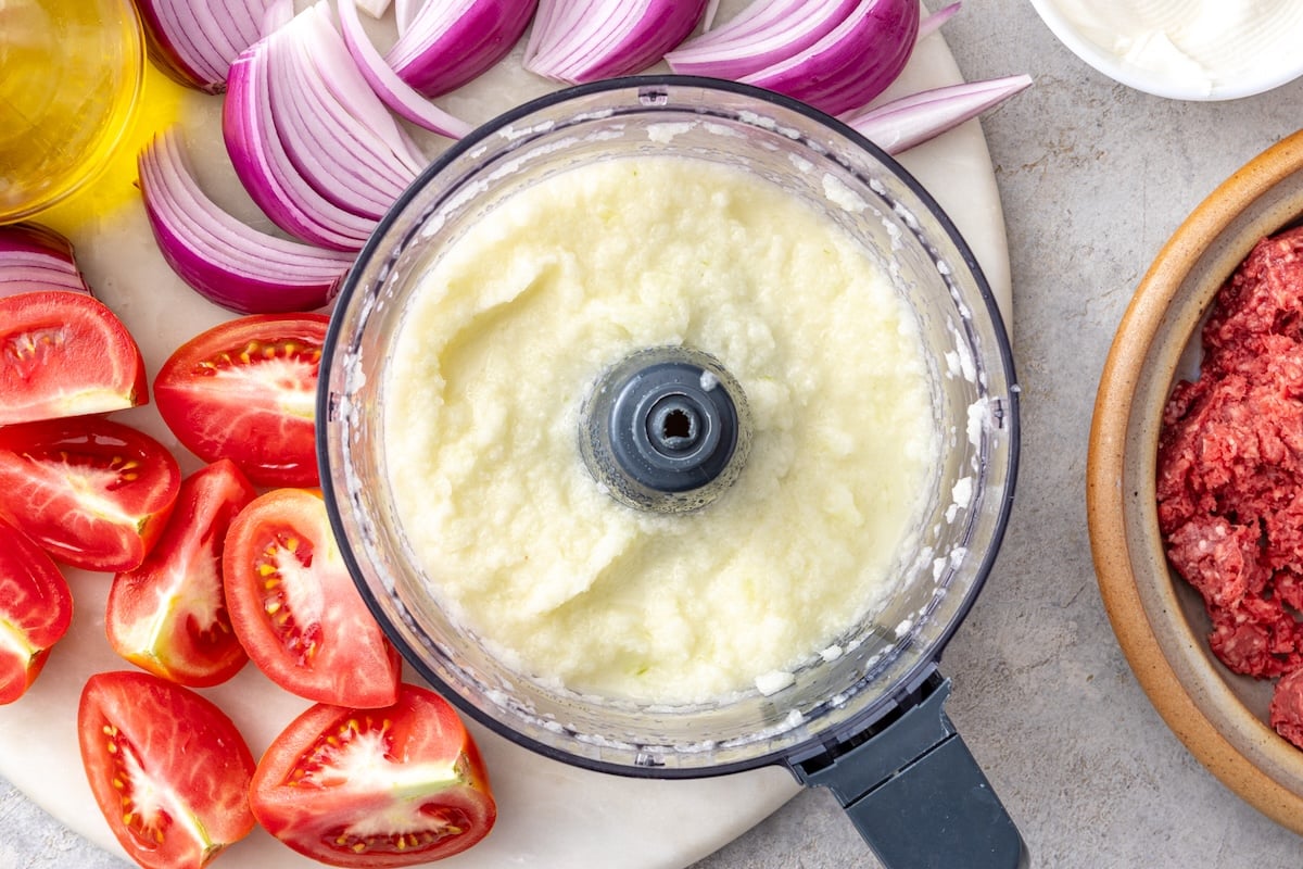 Smooth pureed onion and garlic paste in a food processor for homemade doner kebab.